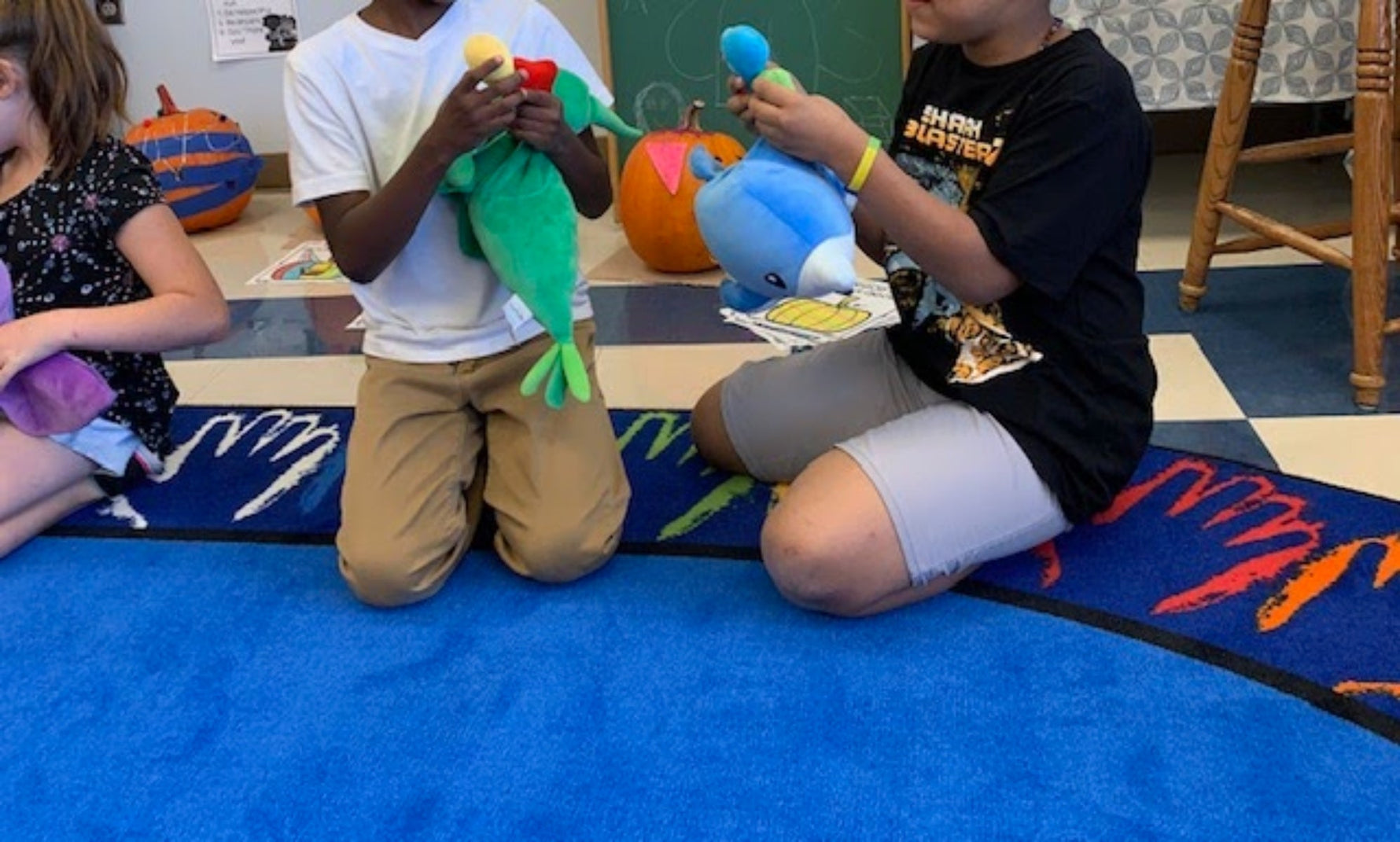 Children sharing feelings with SnuggleBuddies during classroom morning meeting