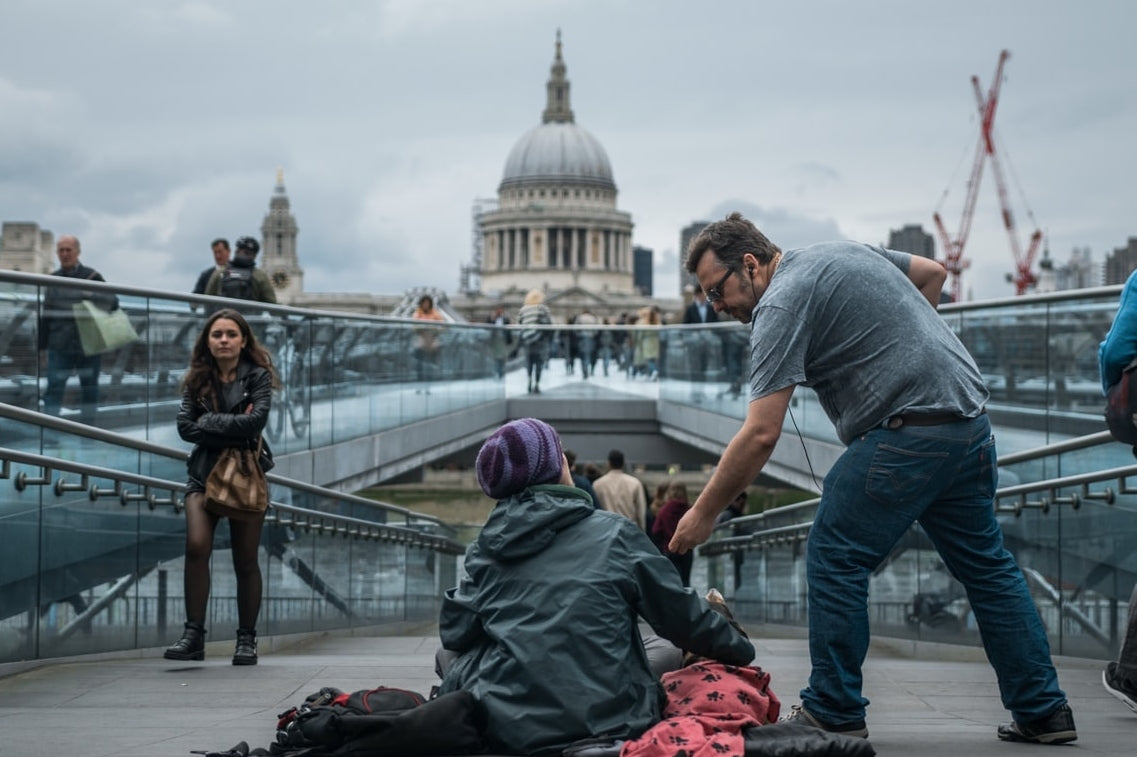 Man giving to a homeless man