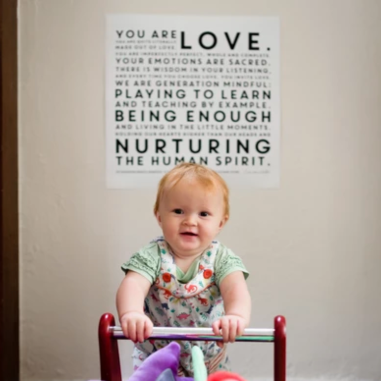 Ava (2) in her playroom displaying the Mindful Manifesto Poster